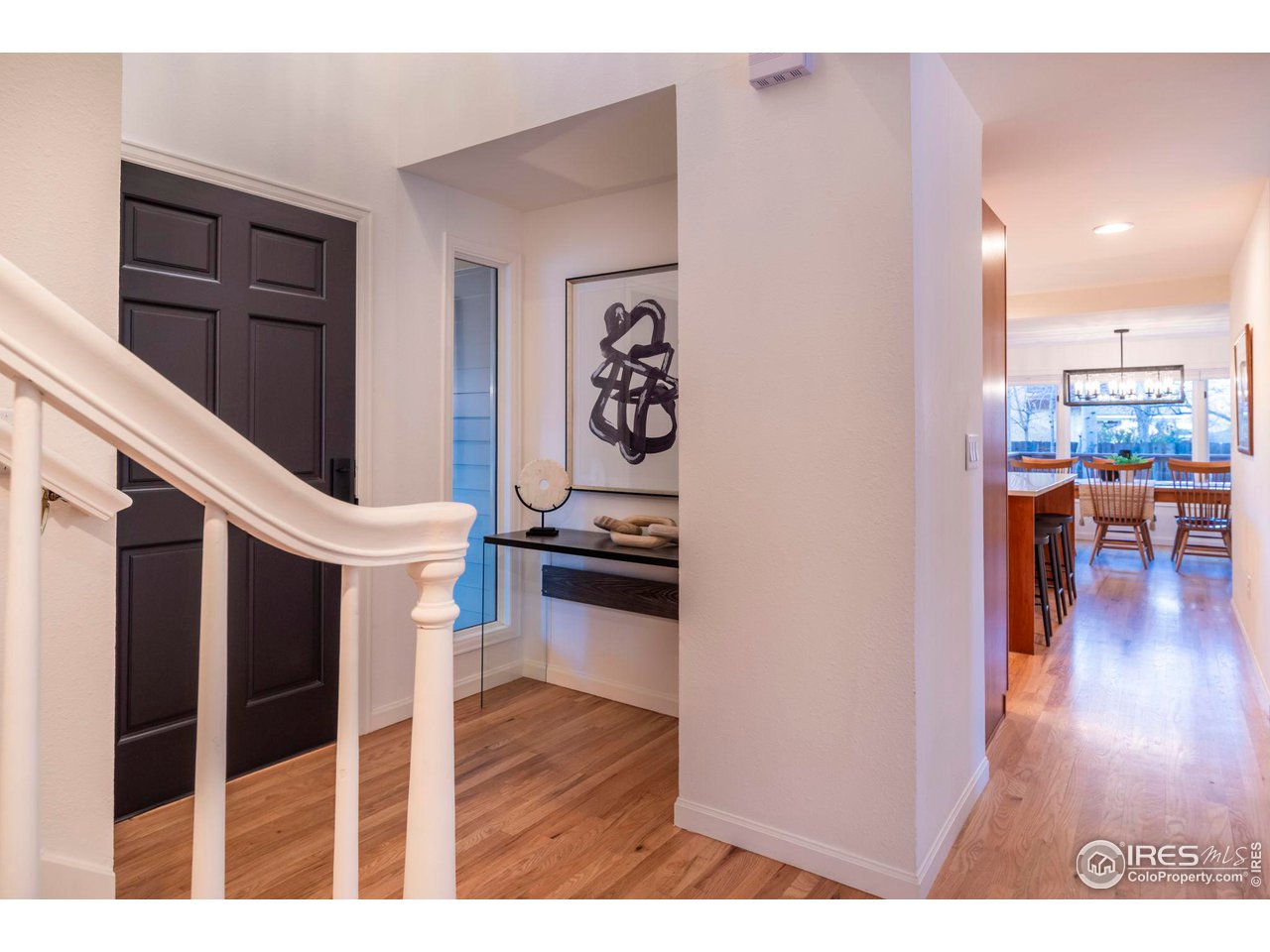5332 Spotted Horse Trail Boulder, CO 80301 - Photo 3 of 40 a living room with furniture a wooden floor and a kitchen