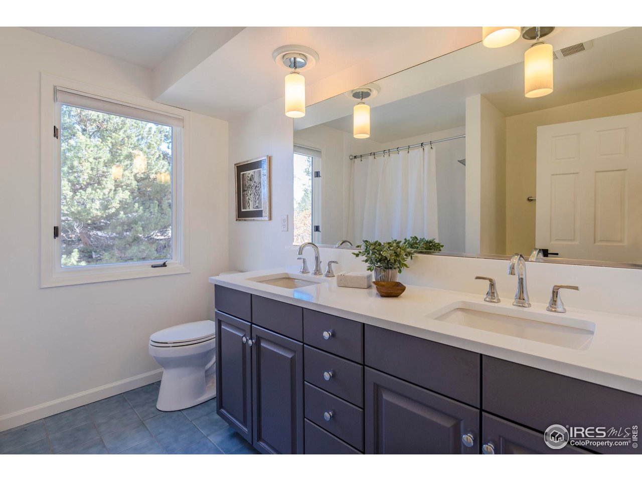 5332 Spotted Horse Trail Boulder, CO 80301 - Photo 31 of 40 a bathroom with a toilet a sink a large mirror and window