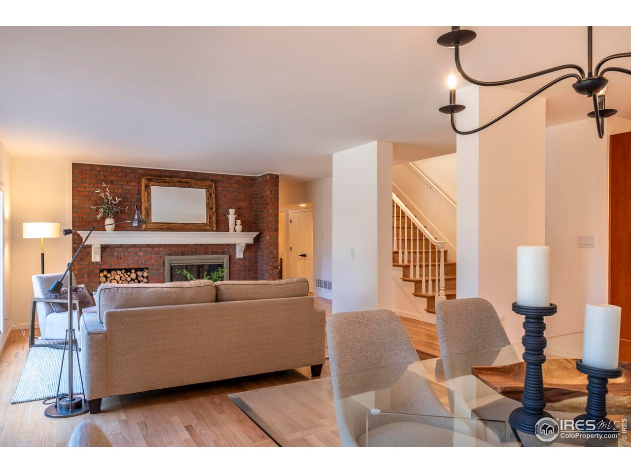 5332 Spotted Horse Trail Boulder, CO 80301 - Photo 8 of 40 a living room with furniture and a chandelier