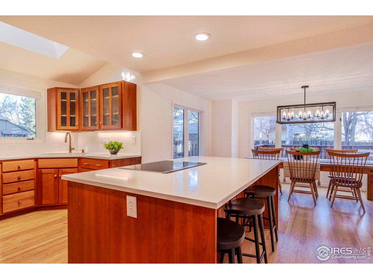 5332 Spotted Horse Trail Boulder, CO 80301 - Photo 10 of 40 a kitchen with stainless steel appliances granite countertop a table chairs and a refrigerator