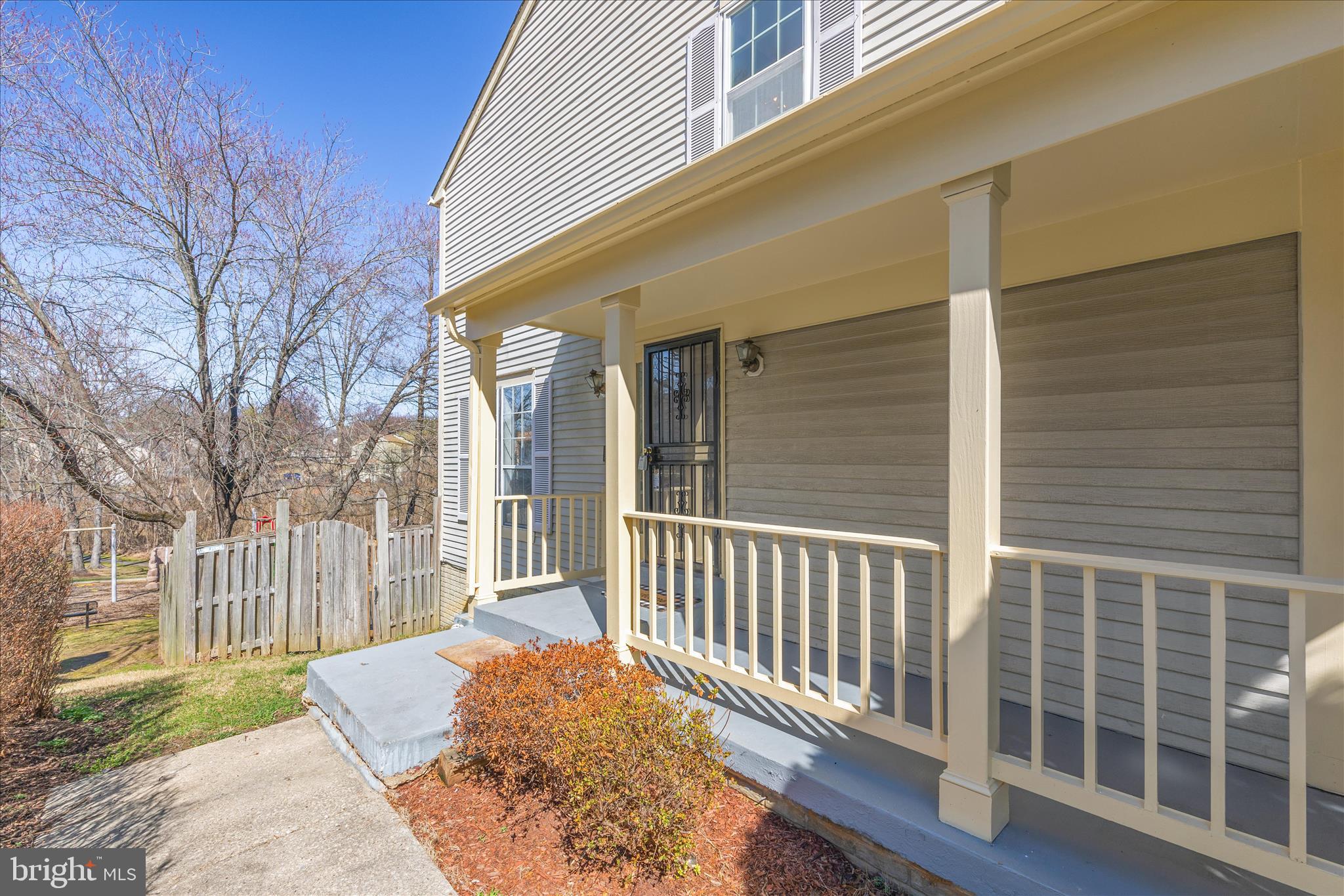 8710 Post Oak Way Landover, MD 20785 - Photo 4 of 38 a porch with a bench next to a yard