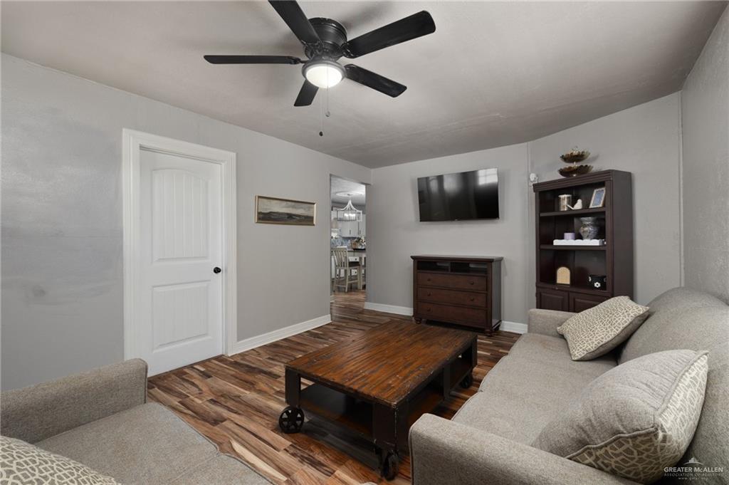 411 East 4th Street Rio Grande City, TX 78582 - Photo 3 of 12 Living area featuring wood-finish flooring, a ceiling fan with integrated lighting, and light grey wall finishes