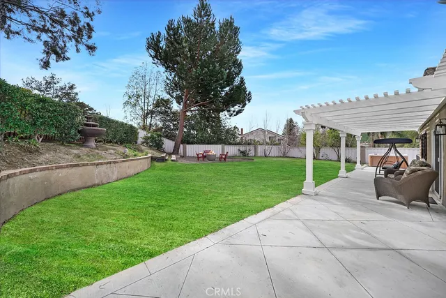 a view of a patio with table and chairs under an umbrella