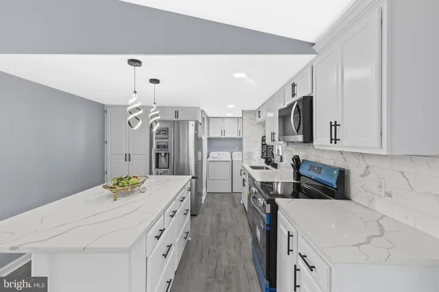 a kitchen with cabinets and wooden floor