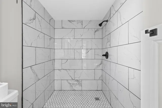a bathroom with white tiles