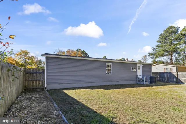 a view of an house with backyard space and balcony