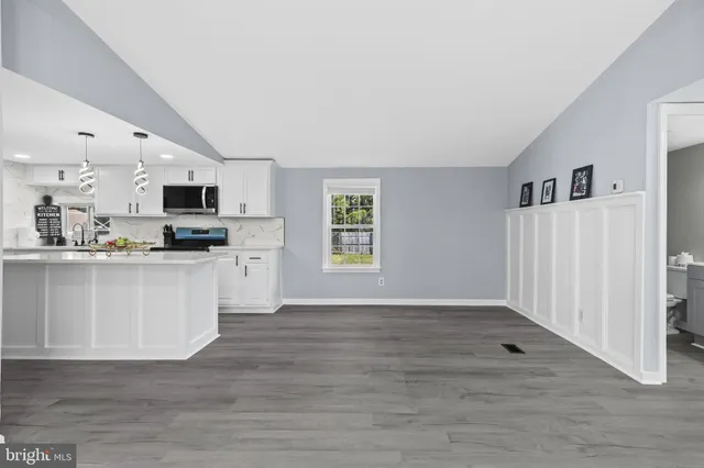 a view of kitchen with wooden floor and electronic appliances