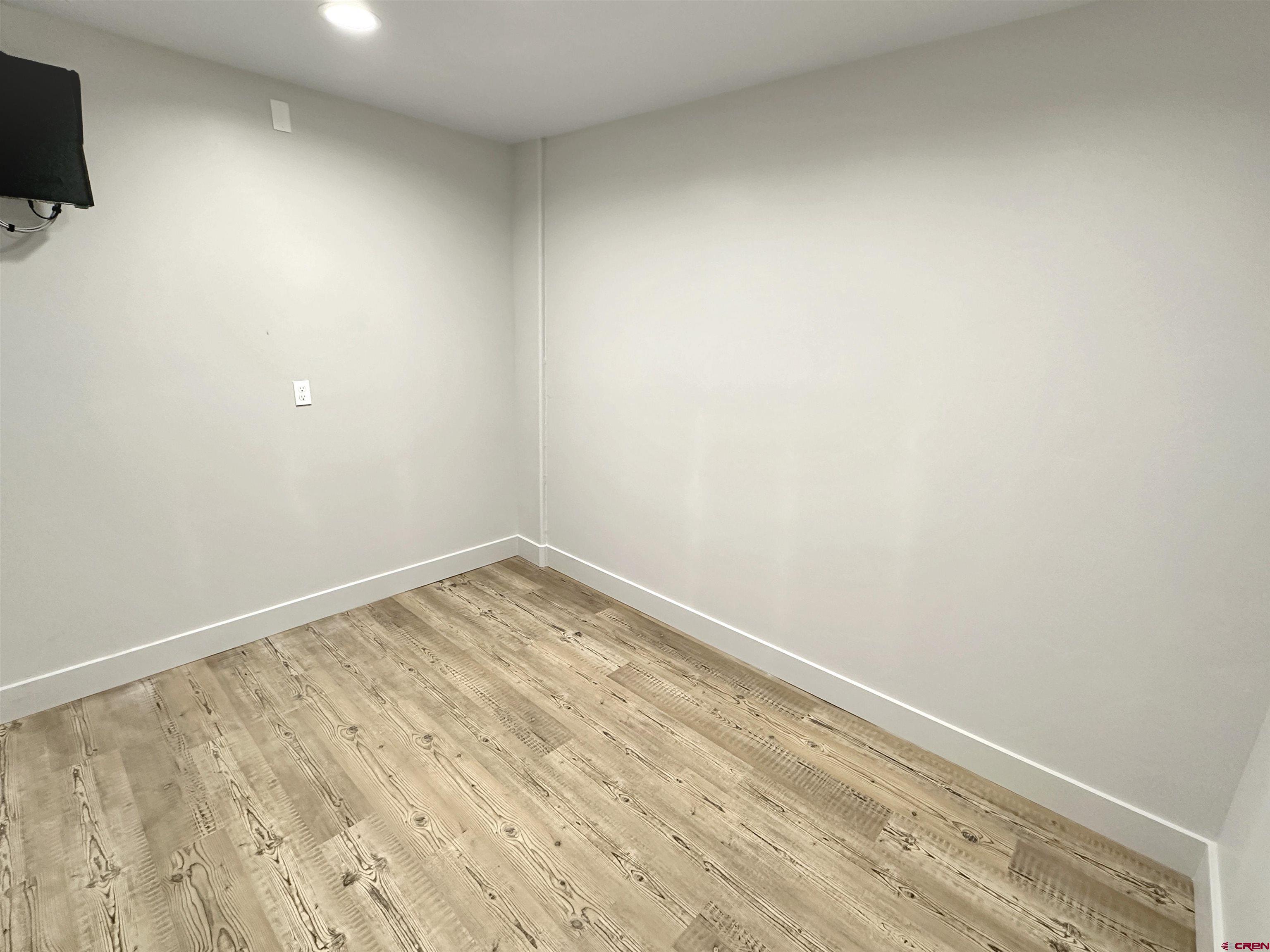 1110 Railroad Avenue, Unit C Dolores, CO 81323 - Photo 4 of 6 a view of empty room with wooden floor and fan