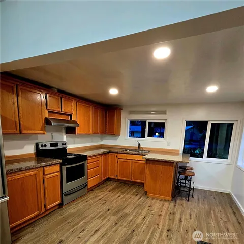 a kitchen with stainless steel appliances granite countertop a sink and cabinets