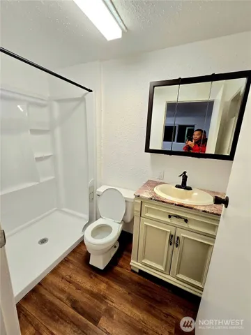 a bathroom with a sink a mirror and a shower