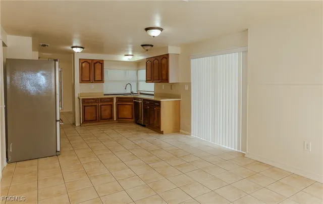 a kitchen with stainless steel appliances granite countertop a refrigerator sink and stove