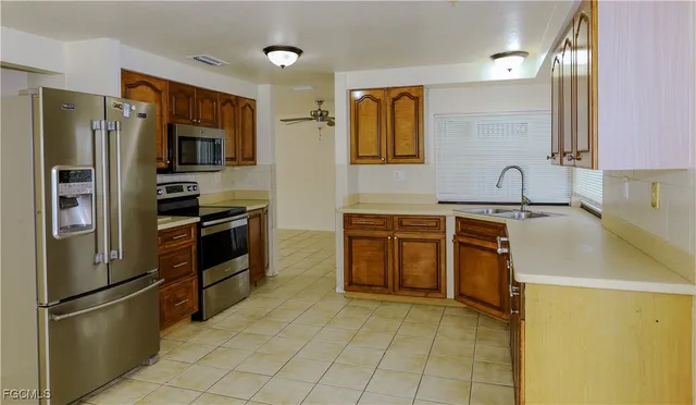 a kitchen with sink and cabinets