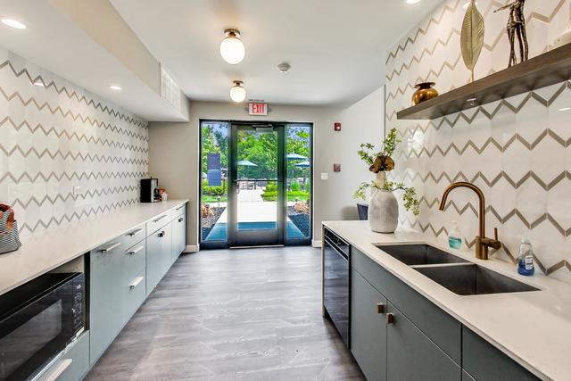 2000 Chestnut Avenue, Unit 407 Glenview, IL 60025 - Photo 20 of 25 a large white kitchen with a large window
