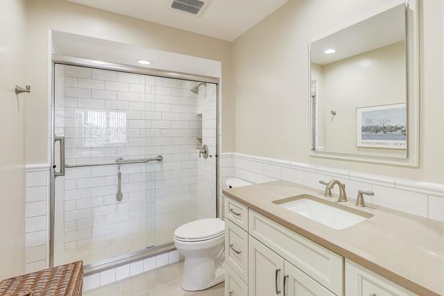2000 Chestnut Avenue, Unit 407 Glenview, IL 60025 - Photo 10 of 25 a bathroom with a granite countertop sink toilet and shower