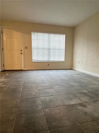 a view of an empty room with a window