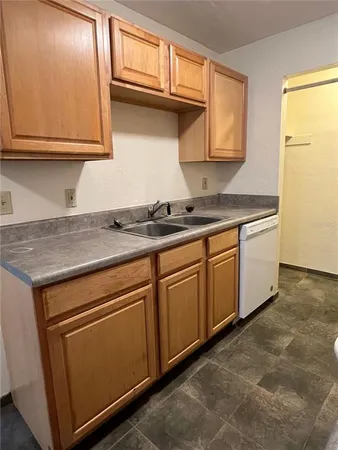 a kitchen with granite countertop cabinets stainless steel appliances and a sink