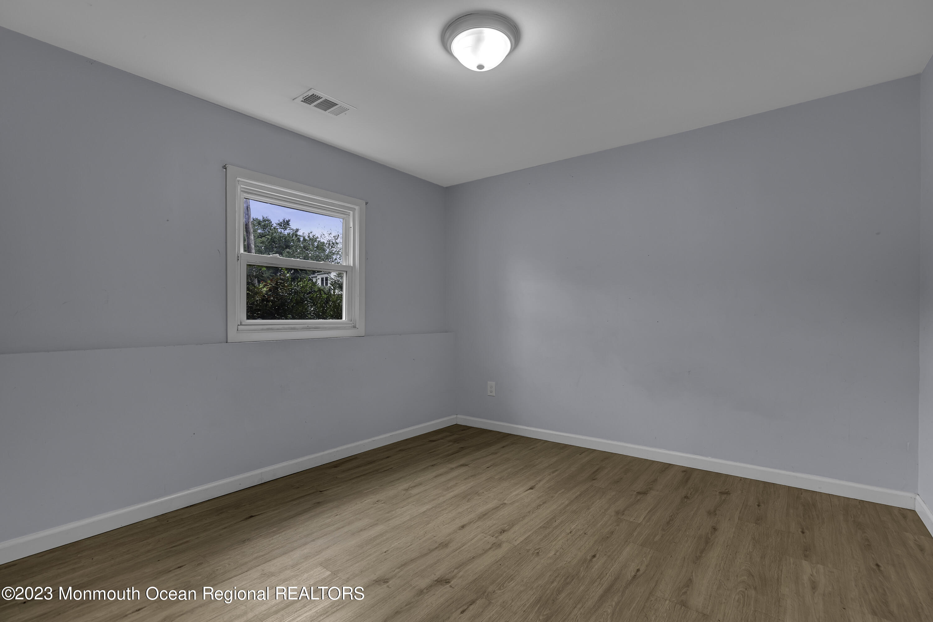 28 Citadel Drive Jackson, NJ 08527 - Photo 17 of 26 wooden floor in an empty room with a window