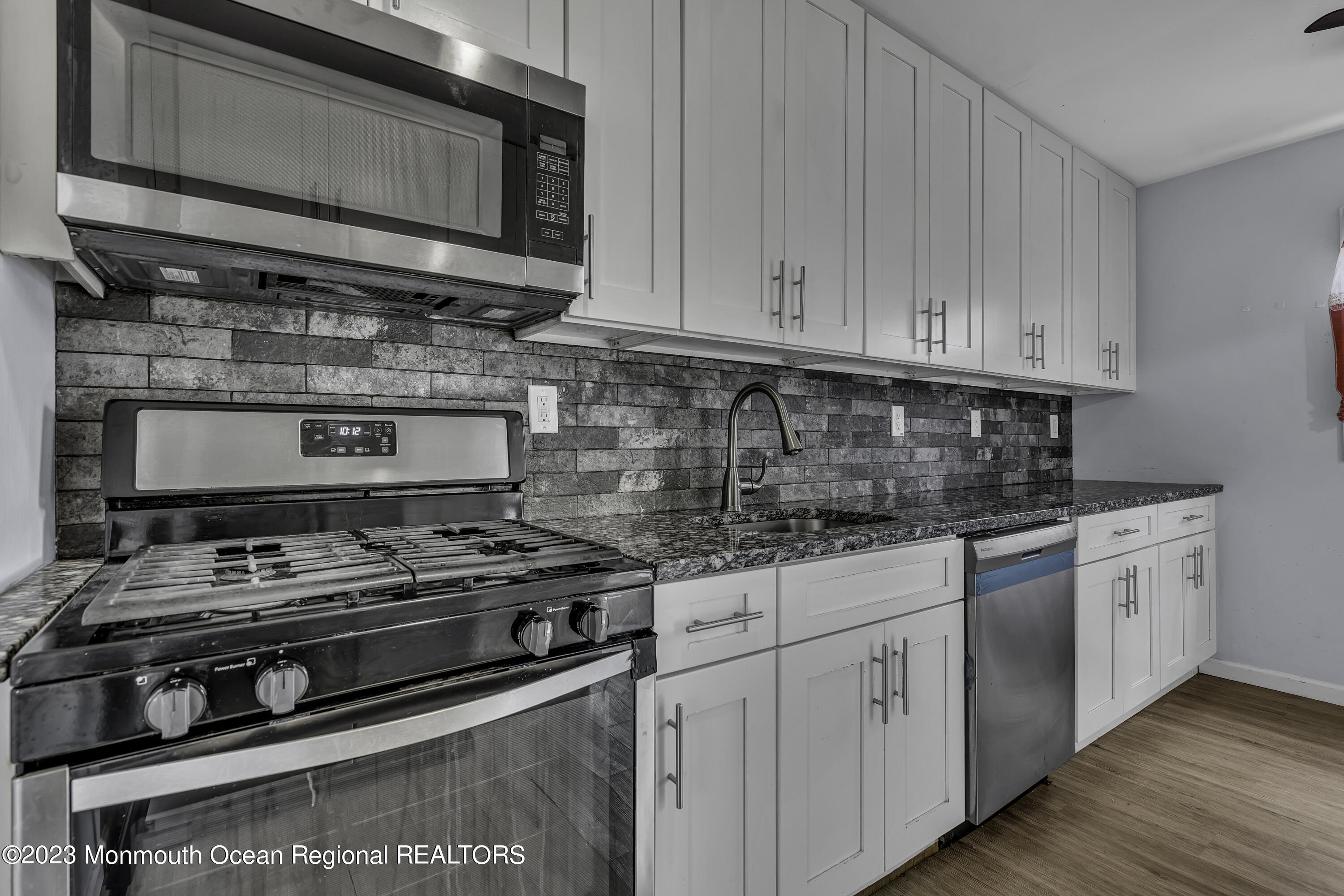 28 Citadel Drive Jackson, NJ 08527 - Photo 7 of 26 a kitchen with stainless steel appliances granite countertop a stove and a microwave