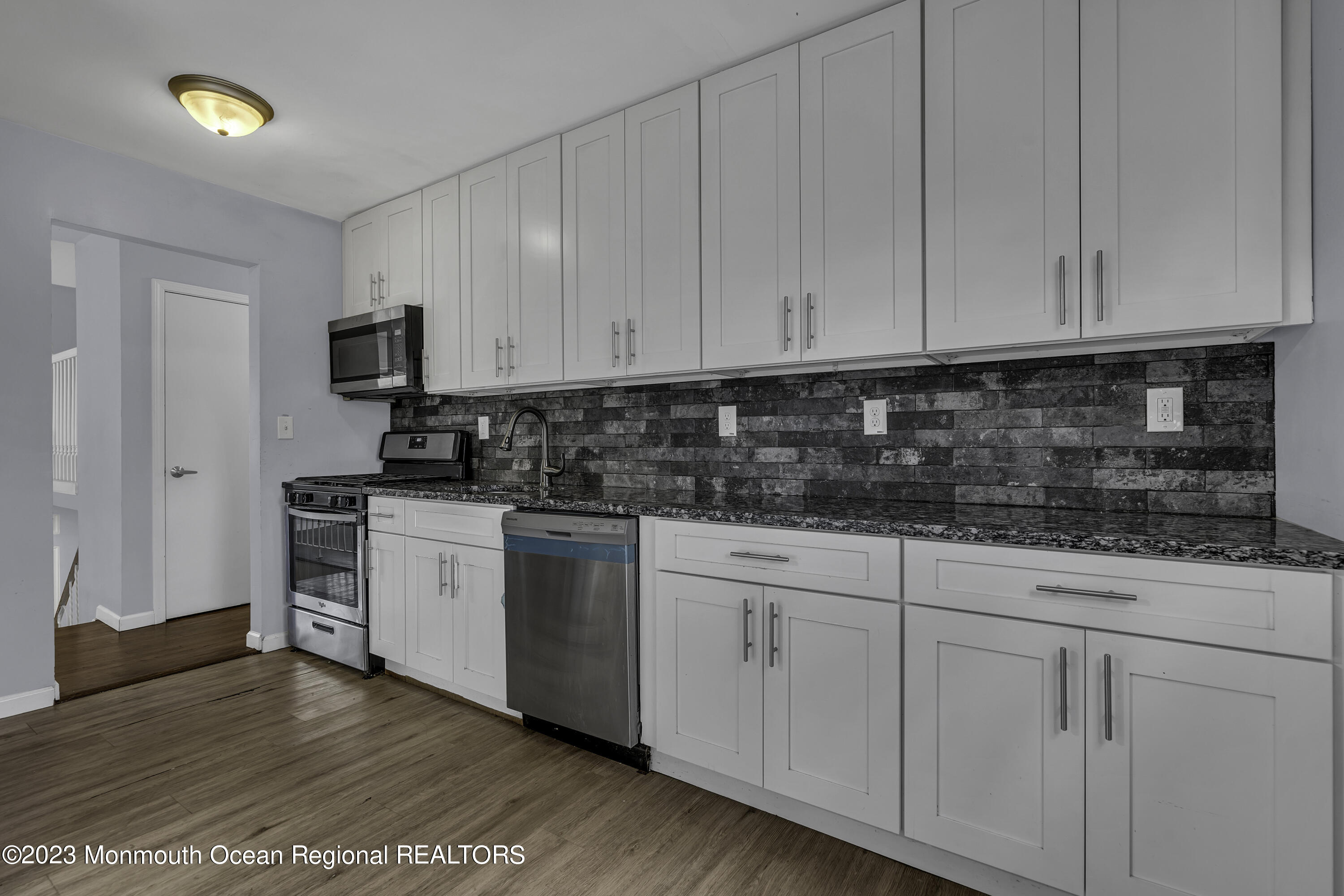 28 Citadel Drive Jackson, NJ 08527 - Photo 8 of 26 a kitchen with granite countertop white cabinets and stainless steel appliances
