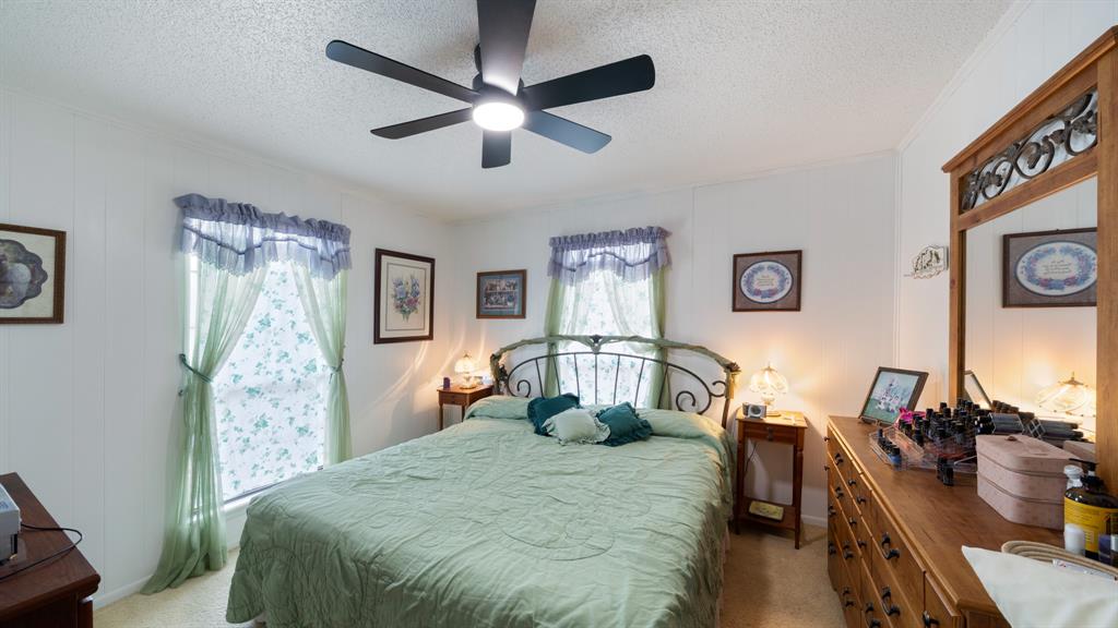 460 VZ County Road Canton, TX 75103 - Photo 17 of 24 Bedroom with light carpet, a textured ceiling, a ceiling fan, and crown molding
