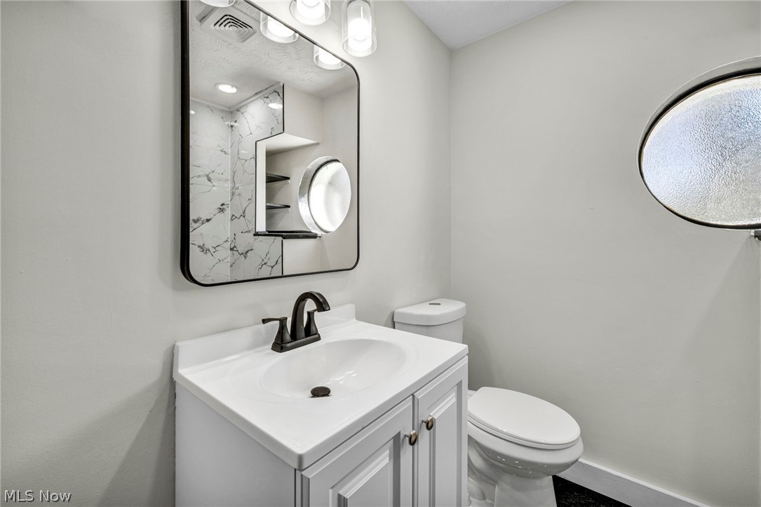 7339 River Road Olmsted Falls, OH 44138 - Photo 26 of 45 White vanity with a rectangular basin sink and matte black faucet