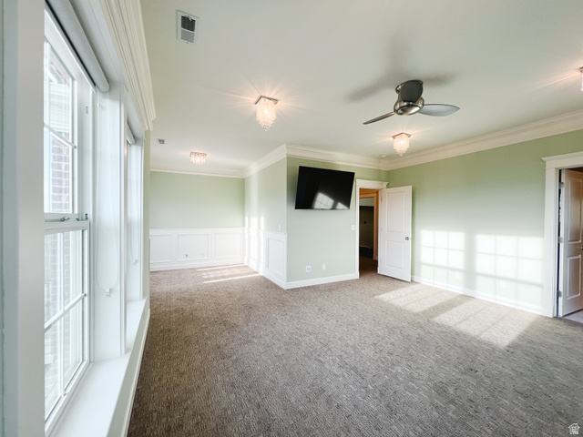 434 Cardon Ridge Drive Smithfield, UT 84335 - Photo 19 of 59 Unfurnished room with plenty of natural light, carpet floors, a wainscoted wall, crown molding, and a decorative wall