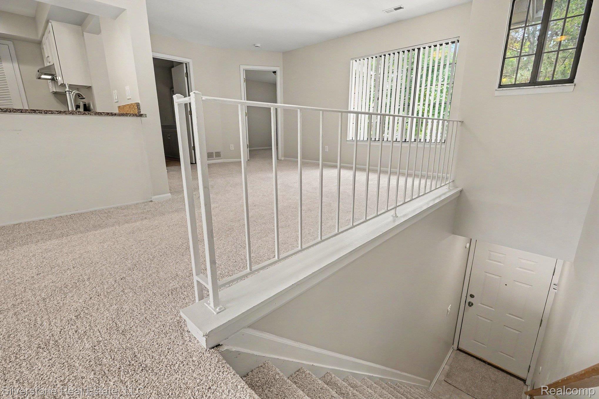1502 Meadowside Drive Rochester, MI 48307 - Photo 4 of 27 Open concept living area with light-toned carpeting and neutral wall finishes
