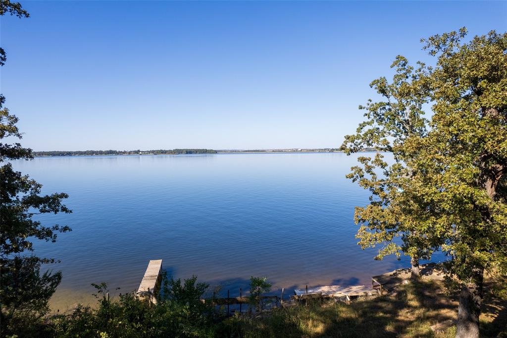 201 County Road Pittsburg, TX 75686 - Photo 6 of 6 a view of a lake with a building in background