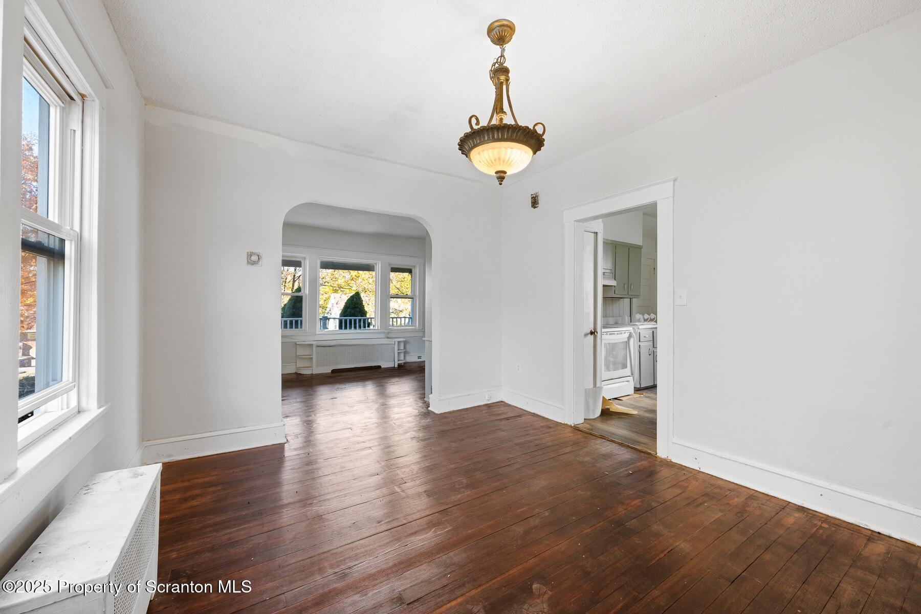 1018 Madison Avenue Scranton, PA 18510 - Photo 5 of 12 an empty room with wooden floor and windows