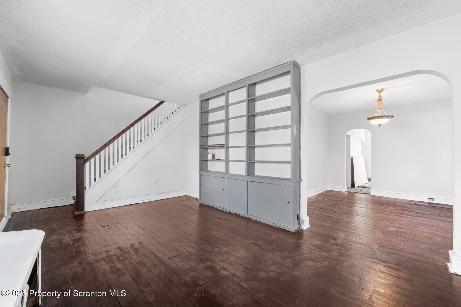 1018 Madison Avenue Scranton, PA 18510 - Photo 6 of 12 a view of an empty room with a window and wooden floor
