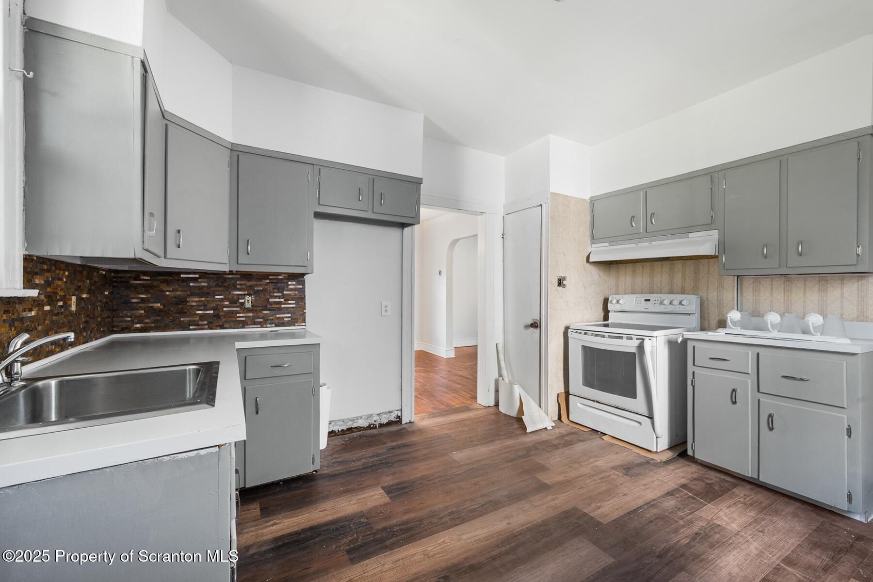 1018 Madison Avenue Scranton, PA 18510 - Photo 7 of 12 a kitchen with granite countertop white cabinets and stainless steel appliances