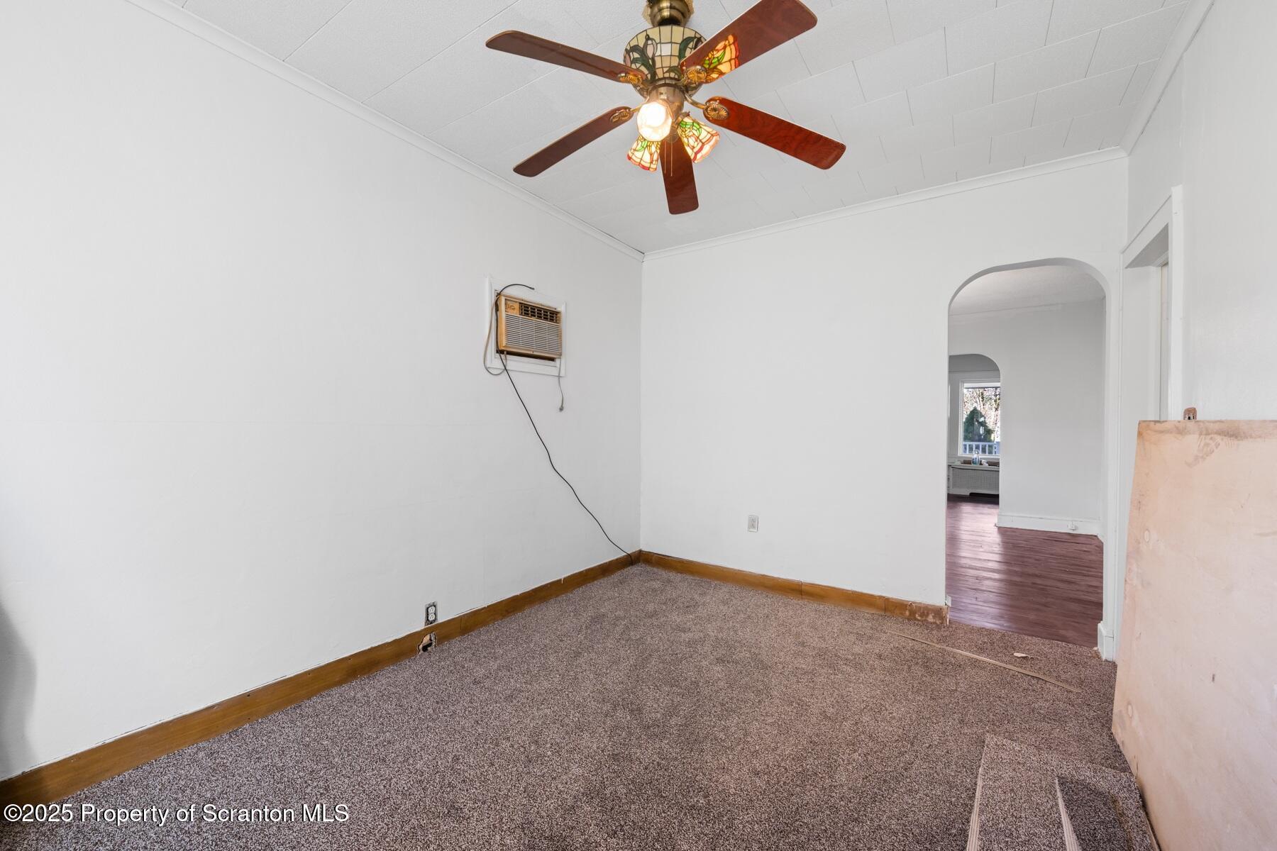 1018 Madison Avenue Scranton, PA 18510 - Photo 10 of 12 an empty room with a ceiling fan and a floor to ceiling window