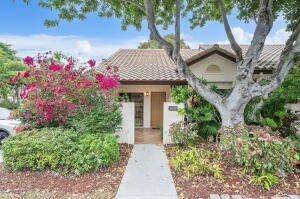 a front view of a house with plants