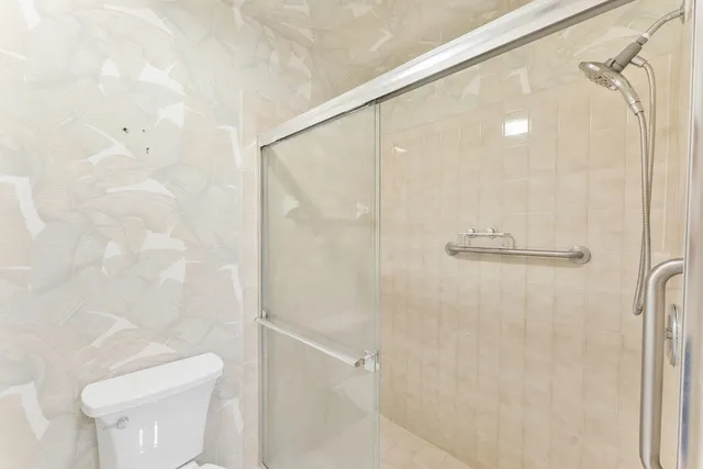a bathroom with a shower and a toilet