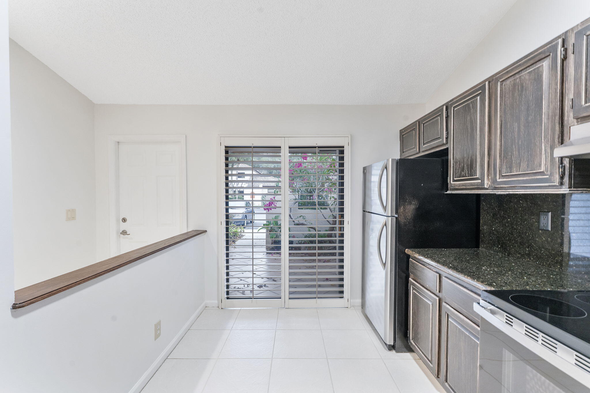 3088 Inglewood Terrace Boca Raton, FL 33431 - Photo 6 of 30 a kitchen with stainless steel appliances granite countertop white cabinets and window