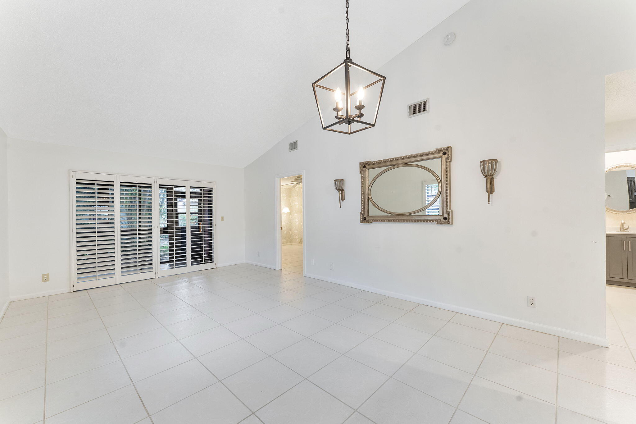 3088 Inglewood Terrace Boca Raton, FL 33431 - Photo 10 of 30 an empty room with windows and ceiling fan