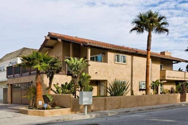 1030 Mandalay Beach Road Oxnard, CA 93035 - Photo 20 of 39 a front view of a house with a yard and garage