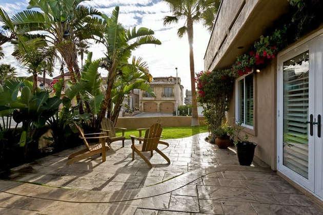 1030 Mandalay Beach Road Oxnard, CA 93035 - Photo 34 of 39 a view of a chair and tables in the patio in front of a house