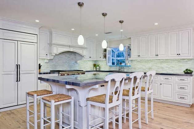 1030 Mandalay Beach Road Oxnard, CA 93035 - Photo 6 of 39 a kitchen with white cabinets and chairs
