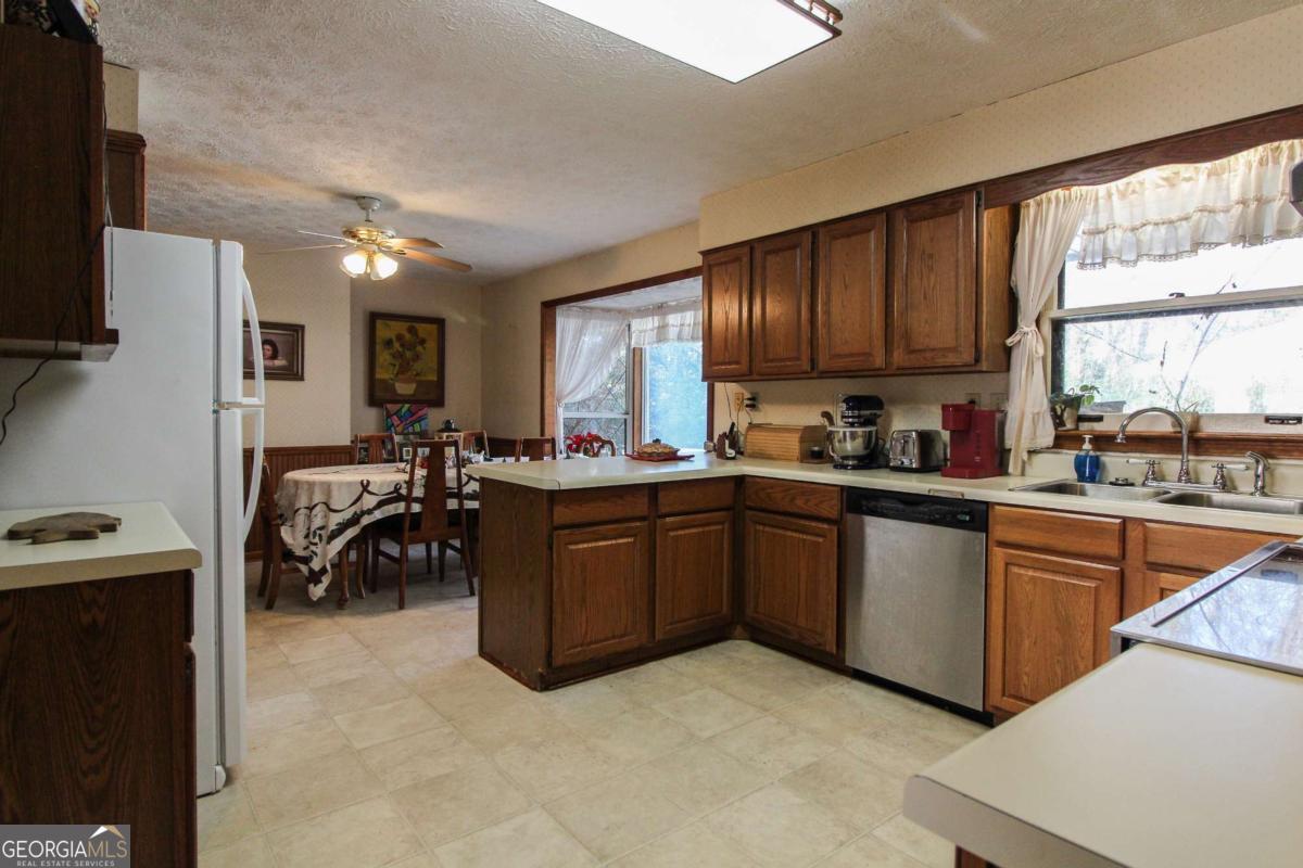 921 Highway 72 Comer, GA 30629 - Photo 11 of 55 a kitchen with cabinets a sink and appliances