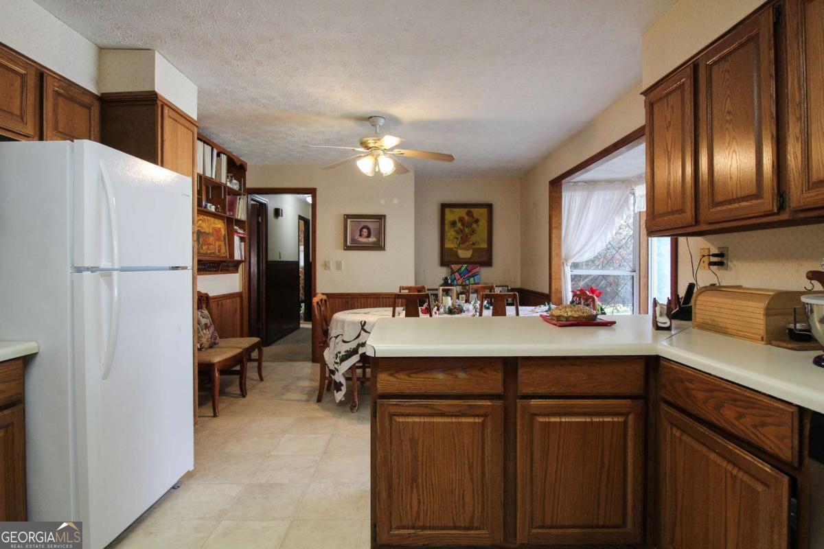 921 Highway 72 Comer, GA 30629 - Photo 13 of 55 a kitchen with stainless steel appliances granite countertop a sink refrigerator and cabinets