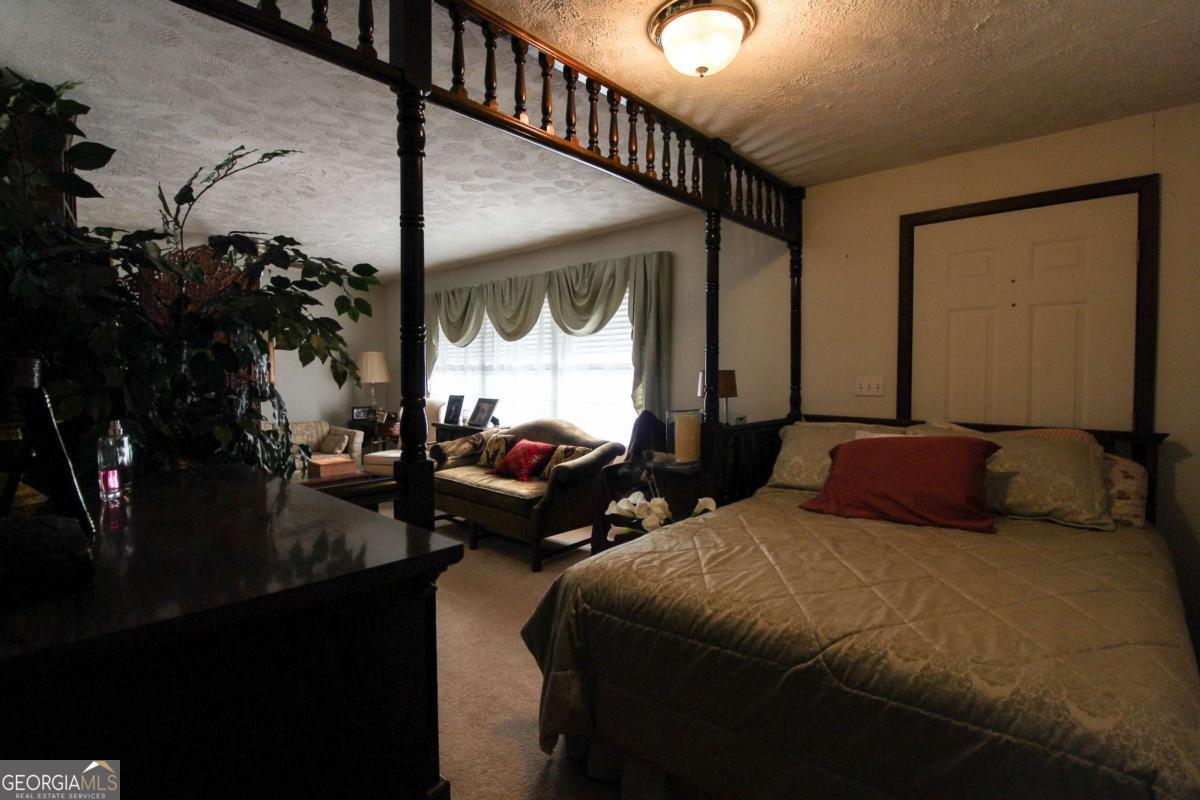 921 Highway 72 Comer, GA 30629 - Photo 20 of 55 a bedroom with two beds and a large mirror