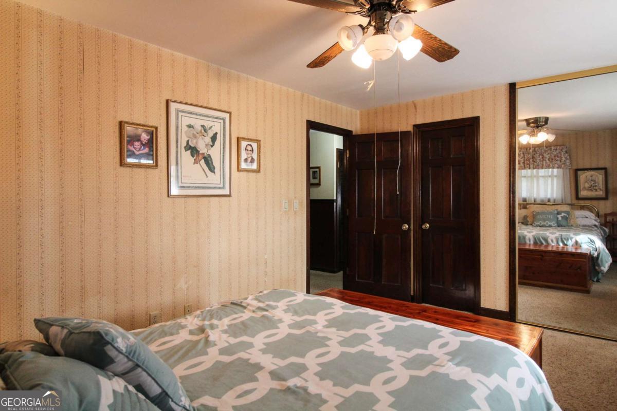921 Highway 72 Comer, GA 30629 - Photo 25 of 55 a bedroom with a bed and a chandelier