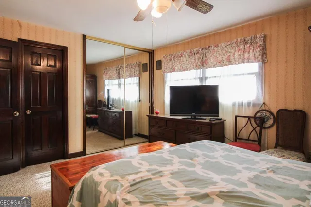 a bedroom with two beds and a window