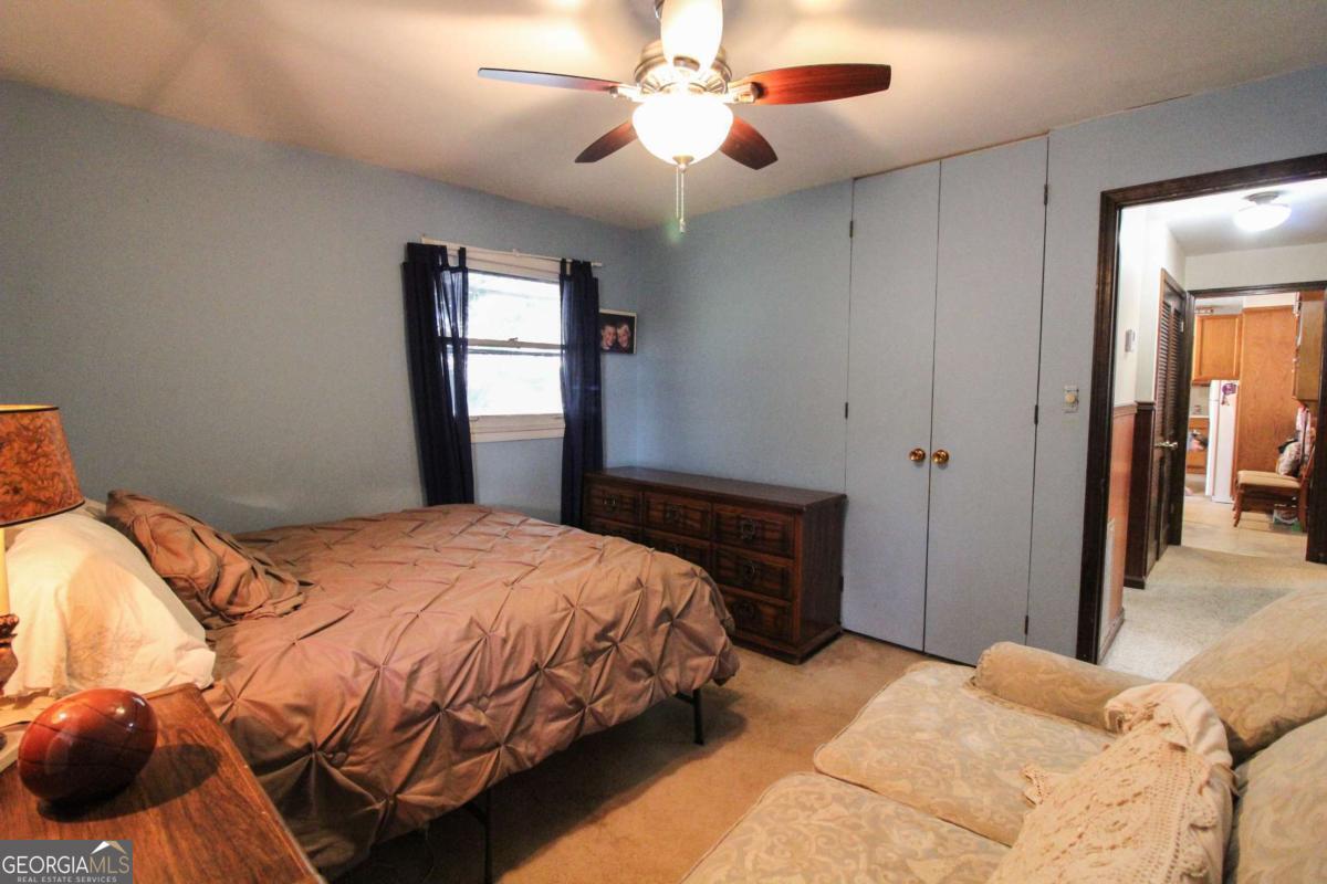 921 Highway 72 Comer, GA 30629 - Photo 31 of 55 a bedroom with a bed and a chandelier