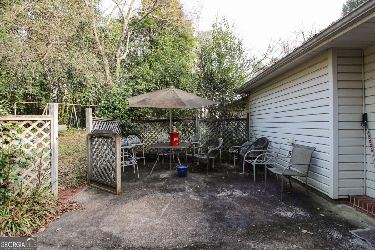 921 Highway 72 Comer, GA 30629 - Photo 35 of 55 a view of a patio with a table and chairs under an umbrella