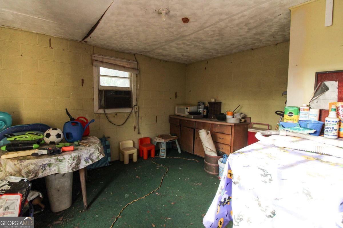 921 Highway 72 Comer, GA 30629 - Photo 39 of 55 a bed room with a bed a desk and a chandelier