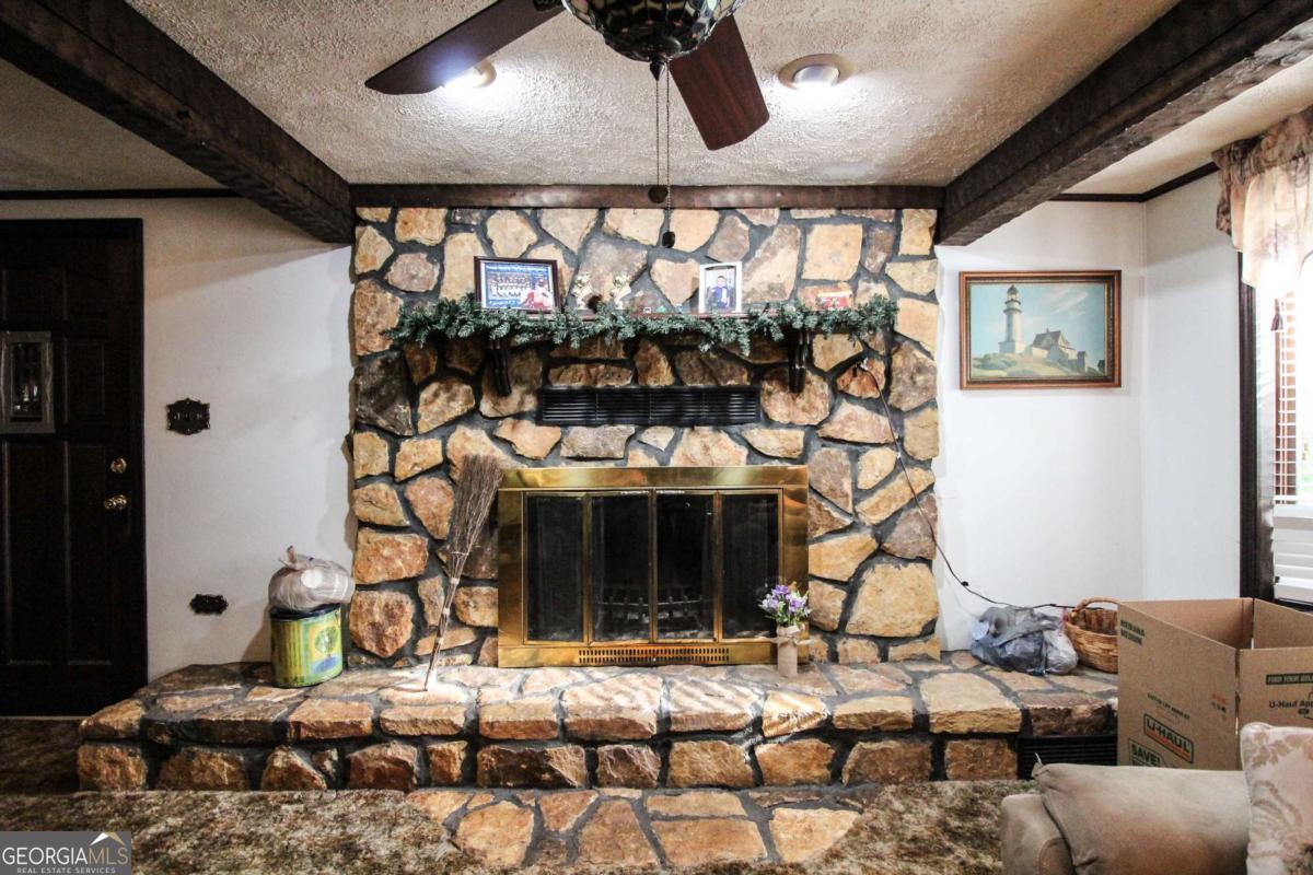 921 Highway 72 Comer, GA 30629 - Photo 7 of 55 a living room with fireplace furniture and a large window