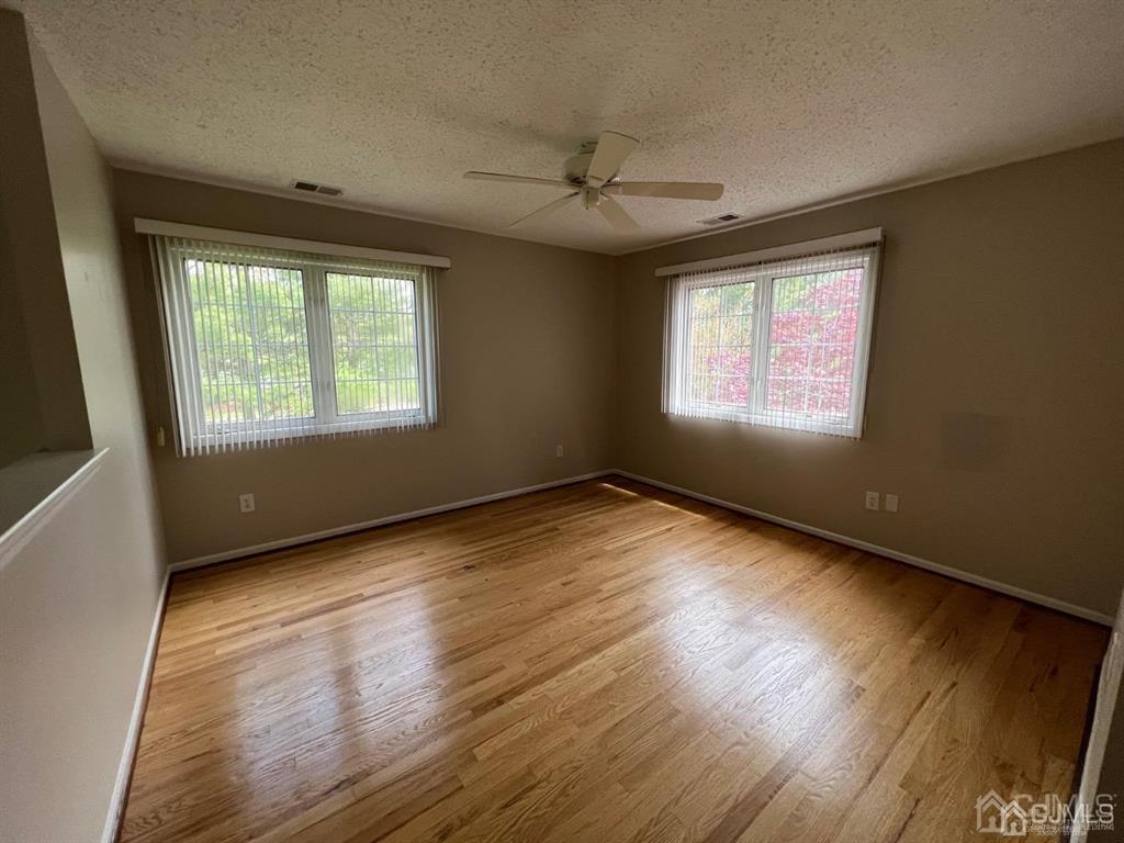 59 Winthrop Road, Unit 59A Monroe Township, NJ 08831 - Photo 13 of 13 a view of an empty room with wooden floor and a window