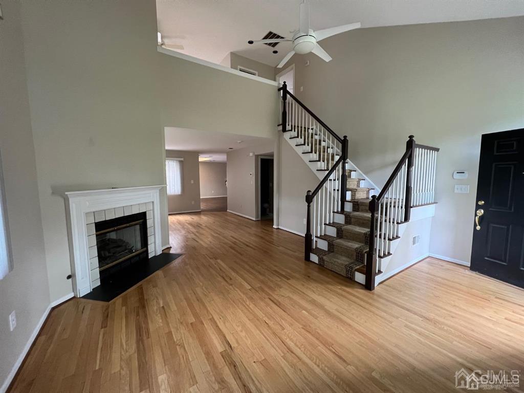 59 Winthrop Road, Unit 59A Monroe Township, NJ 08831 - Photo 2 of 13 a view of a livingroom with wooden floor and a fireplace